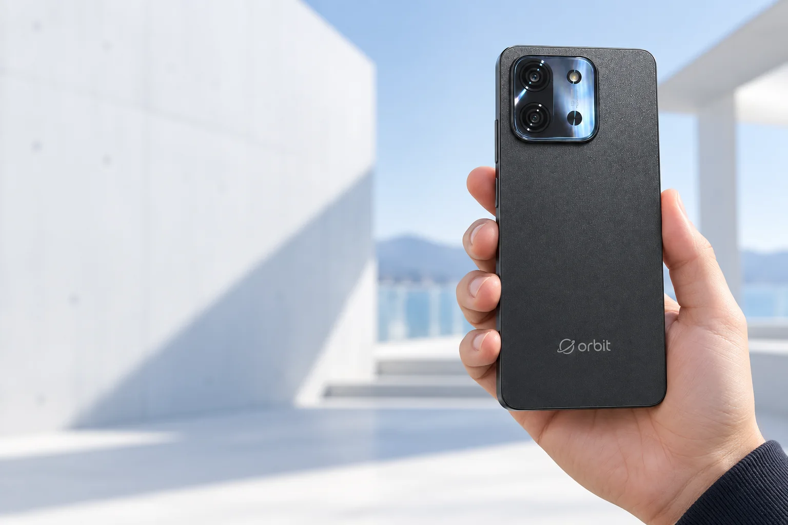 Graphite Orbit 1 smartphone held in a bright contemporary space